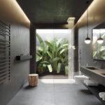 Dunkel eingerichtetes Badezimmer mit Betonwänden und modernem Minimaldesign mit Blick auf Palmen.