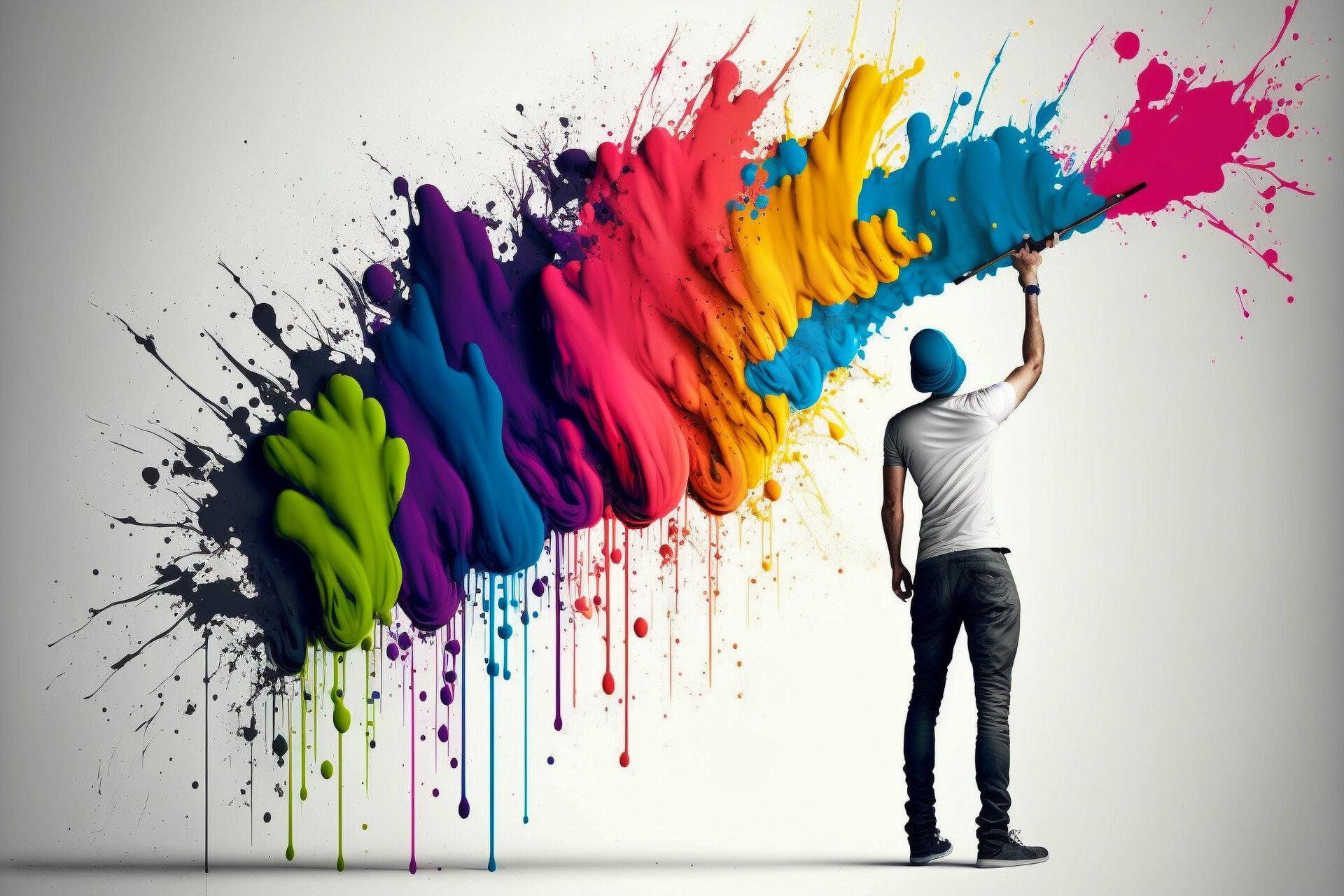 Lustiger Maler streicht eine weiße Wand bunt mit color splash